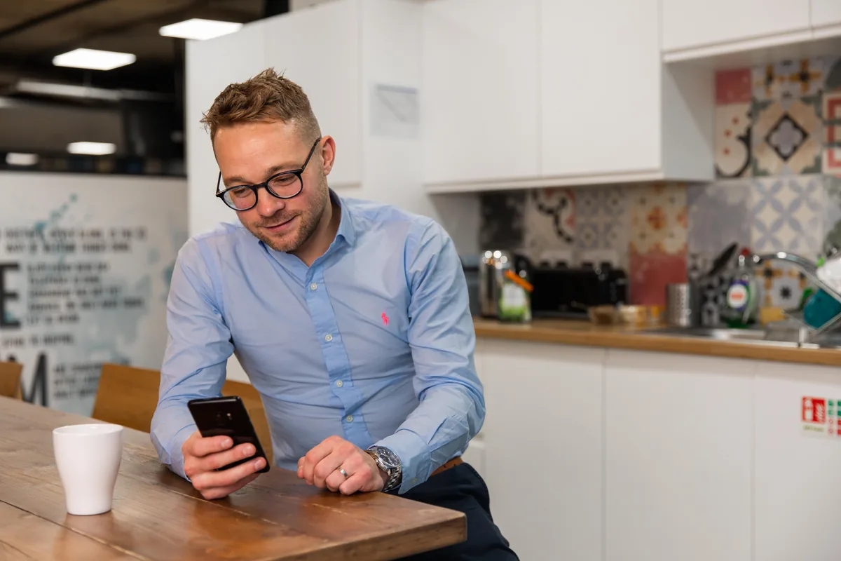 A jobseeker looking at vacancies on his phone